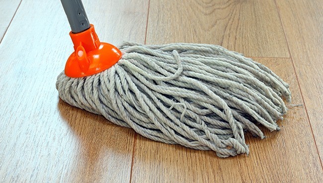 detail of a mop cleaning wooden floor