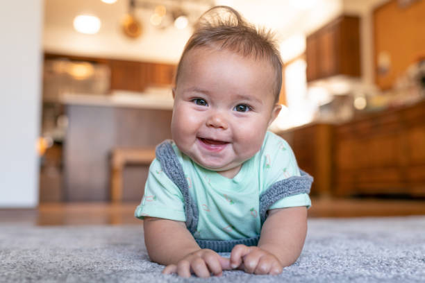 Baby laying on carpet | The Flooring Center